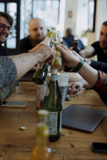 Team members of tech and design agency Tahiiti Enterprises Ltd clinking glasses of sparkling water and lemonade during a team building event